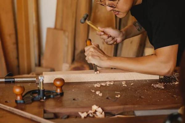 A person installing LVP floors through the DIY method.