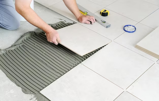 A man installing LVT floors through the DIY method.