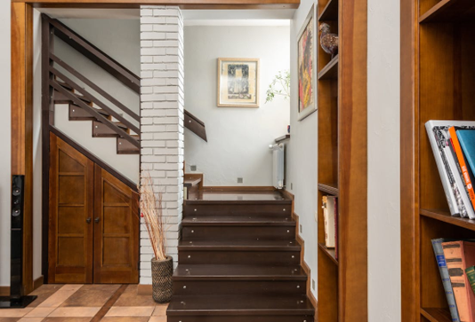 Luxury vinyl plank flooring on stairs connecting one house floor with the other.