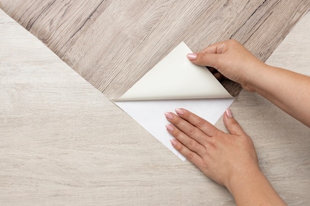 A woman installing a quality sheet vinyl flooring.